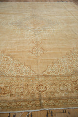 Distressed Indian Tabriz border detail with turtle Samovar motif, low pile, and curled edge.