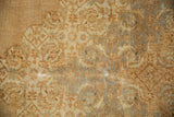 Vintage distressed Indian Tabriz carpet pile, showing wear and faint foundation through faded patterns.