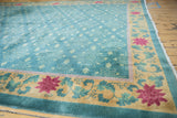 Chinese Nichols Art Deco rug corner: gold border, raspberry lotus flowers, teal floral field.