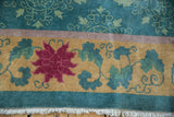 Art Deco carpet border: cochineal red lotus, pale green vines, mauve stripe, and fringe.