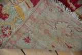 Hand-knotted reverse of Oushak rug, with intact side cord, muted tones, and fringe.