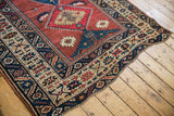 Vintage Northwest Persian runner detail: diamond medallion featuring cochineal red, navy, and beige serrated designs.