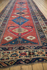 Cochineal red and navy diamond medallions, serrated patterns, and crab style geometric border.