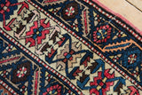Serrated geometric design, indigo blue, brick red, and beige pile with original red selvage.