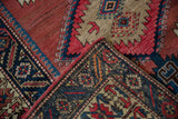 Folded corner of vintage Northwest Persian runner, cochineal red, navy geometric patterns, woven back.
