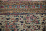 Antique Kerman rug featuring intricate golferang rose bouquets and floral border in ivory, red, blue.