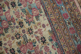 Antique Kerman runner detail: intricate cochineal red golferang rose bouquets and striped terracotta border.