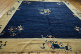 Peking carpet corner shows cobalt blue field, dusty gold border with floral motif, secure ends.