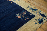 Pictorial vase motif on dusty gold border of vintage Peking rug's cobalt field.