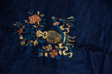 Peking carpet's central gold vase design with dusty rose blossoms on a cobalt field.