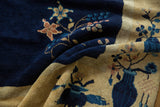 Peking carpet detail of cobalt blue floral field and antique ivory pictorial vase border.
