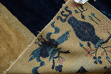 Vintage Peking carpet close-up: cobalt blue vase design, gold field, and hand-knotted back.