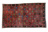 Antique Caucasian carpet, dusty raspberry field, staggered floral and geometric lattice design, 5' x 8'10