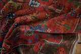Antique Caucasian rug pile, dusty raspberry abrash, indigo floral blossoms.