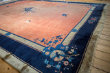 Lustrous copper field and indigo blue floral border on a vintage Chinese Peking carpet.