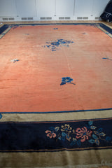 Cobalt blue border with pale rust and light blue floral motifs on Peking carpet.