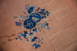 Textural detail of the vintage Peking carpet's field, revealing time-softened copper and pale rust tones.
