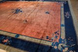Vintage Peking carpet corner with time-softened copper field, indigo border, and auspicious motifs.