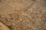 Distressed vintage Tabriz carpet showing worn Herati design in coffee brown, bronze, and pale blush.