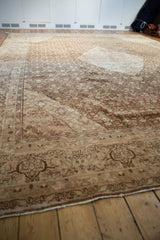 Worn border detail on vintage distressed Tabriz carpet, with coffee brown and blush patterns.