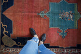 Antique Tabriz carpet with geometric navy Samovar spandrel, madder red field, floral border.