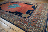 Antique Persian Tabriz carpet corner with navy Samovar design, madder red abrashed field, and patterned outer borders.