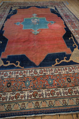 Antique Tabriz carpet: madder red field, indigo Samovar spandrel, and ornate floral border detail.