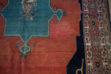 Madder root red field and intricate traditional border on an antique Tabriz rug.