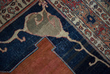 Geometric Samovar spandrel in muted tones, rich indigo field, and brick red design on antique Tabriz carpet.