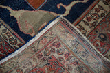 Antique Tabriz Carpet corner showing indigo pile wear, blue selvage, and woven back foundation.