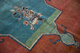 Detail of antique Tabriz carpet, unique floral bouquet on teal field with madder red.