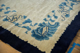 Vintage Peking carpet's scalloped indigo border with ivory field and blue lotus motif.