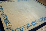Vintage Peking carpet's blue floating border with cloud motifs and subtle ivory field pattern.