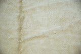 Close-up of vintage Peking carpet's tone-on-tone ivory and beige pile with textural line.
