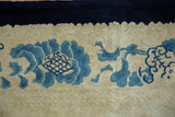 Scalloped ivory border of a vintage Peking carpet with cobalt blue palmettes.