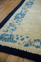 Vintage Peking carpet border with layered ivory and sky blue cloud motifs.
