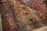Antique Halvai Bijar rug close-up revealing wear across knot heads, saffron yellow field, and green minor border.
