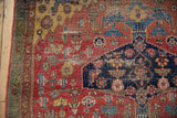 Rare green minor border, saffron yellow spandrel, cherry red field, floral motifs, and visible foundation wear.