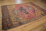 Antique Halvai Bijar rug's unique saffron yellow spandrel, green minor border, and aged pile.