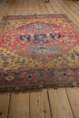 Worn fringe, unique green border, and saffron yellow detail on an antique Halvai Bijar rug.