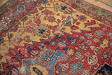 Worn cherry red field of antique Halvai Bijar rug, detailed florals, saffron accents, and visible foundation.