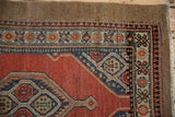 Geometric corner spandrel and floral border detail on a fine Camel Hair Serab vintage rug.
