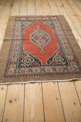 Low angle perspective of the vintage Serab rug, showing its even wear and camel hair border.