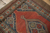 Detail of a Persian Serab rug's corner, showing the geometric spandrel and multi-layered floral border.
