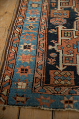 Hand-knotted Karaja rug detail: sky blue starburst border and geometric navy field.