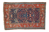 Vintage Hamadan rug featuring a navy millefleur field and madder red floral border.