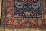 Vintage Hamadan rug corner, madder red border, navy field with tree motif, tattered fringe.