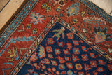 Vintage Hamadan rug detail: navy field with stylized millefleur, madder root red border of serrated leaves.