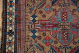 Kurdish Hamadan rug displaying geometric patterns in madder red, dusty teal, and striped border.