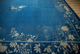Vintage Peking carpet border featuring ivory floral vinery and cobalt blue field wear.